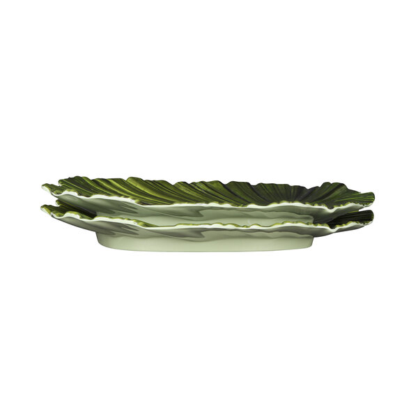 A green and white Elite Global Solutions palm leaf melamine platter with a leaf design.