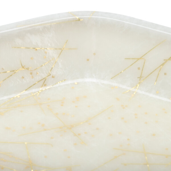 A white Cambro tray with gold lines and yellow dots.