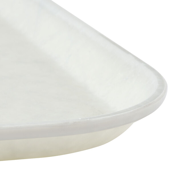 A close up of a white Cambro fiberglass tray with a trapezoid design.