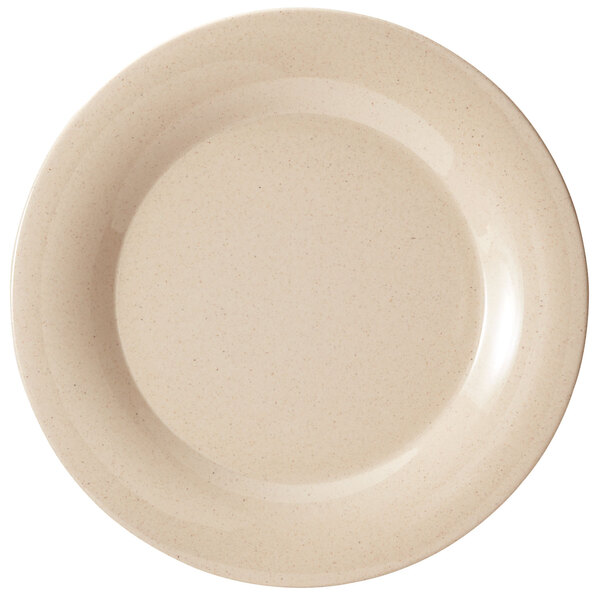 A beige plate with a white speckled rim.