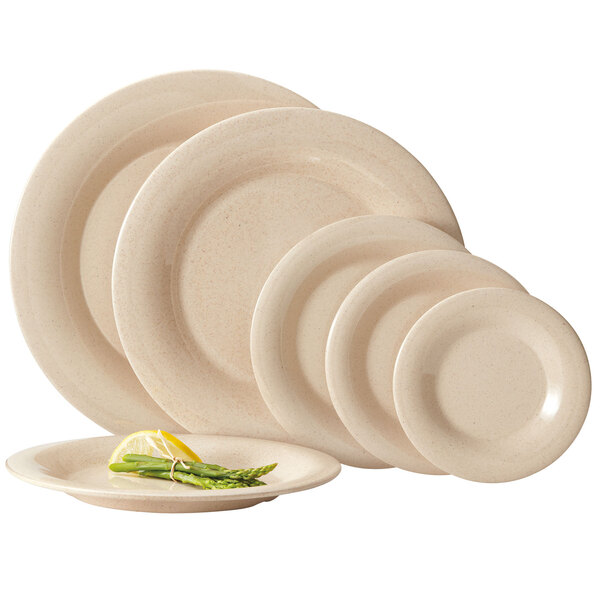 A stack of GET BambooMel white plates with a lemon slice on top.