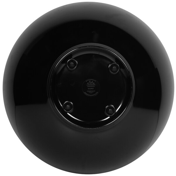 A black round melamine bowl with a sunburst design.