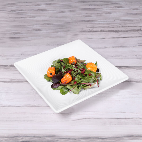 An Elite Global Solutions white square melamine tray with a salad on it.