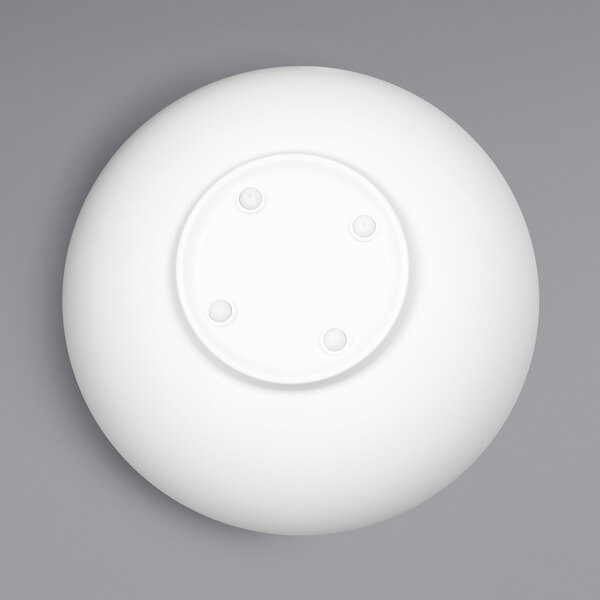 A white melamine bowl with a sunburst pattern on a gray background.