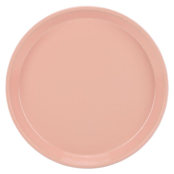 A pink Cambro round tray with a white background.