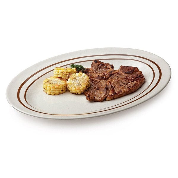 An Ironstone oval platter with a steak and corn on it.