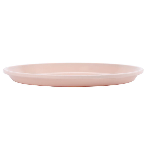 A light peach Cambro round tray on a white background.