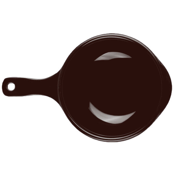 A close-up of a brown bowl with a handle.