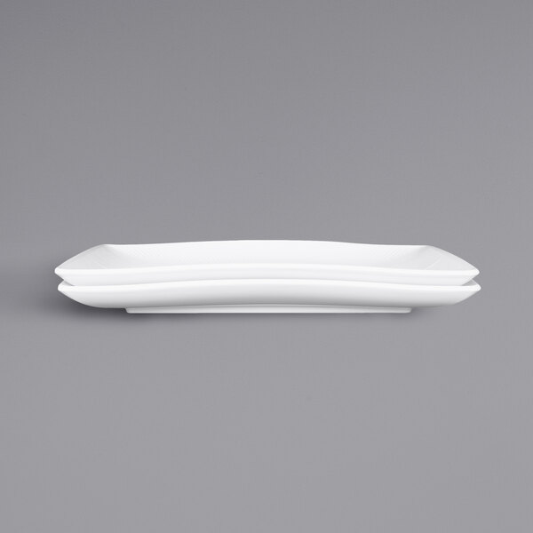 A white rectangular melamine tray with two white rectangular melamine trays on it.