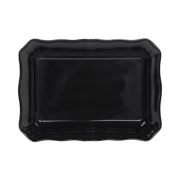 A black rectangular melamine dish with a scalloped edge.