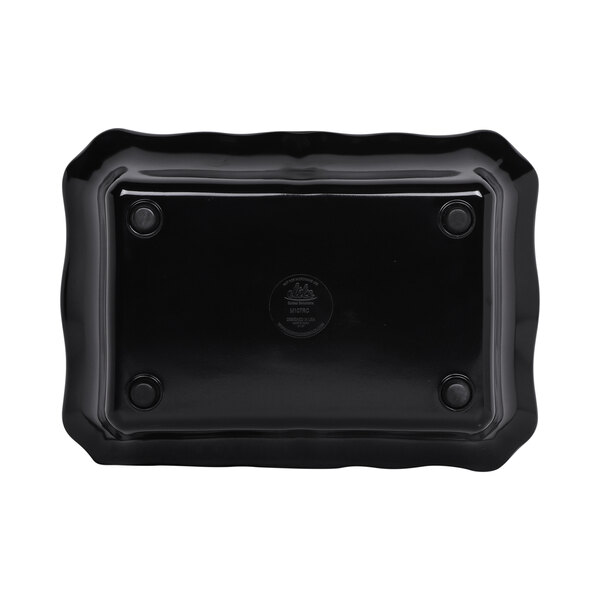 A black rectangular melamine bowl with a scalloped edge.