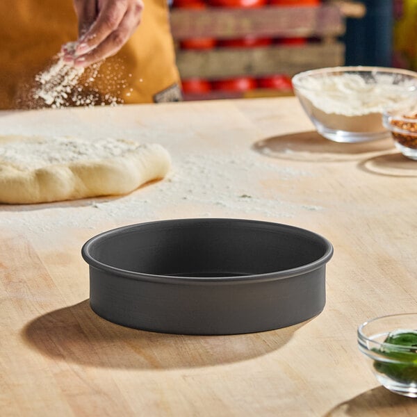 An 8-inch by 2-inch hard coat anodized aluminum straight sided pan for cakes or deep dish pizza.