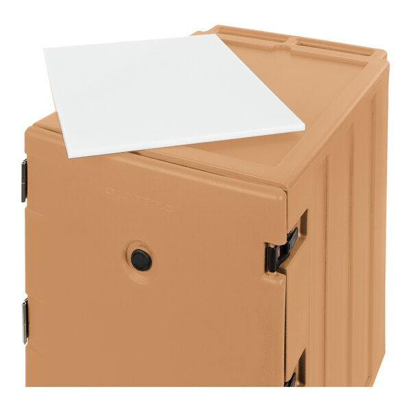 A beige mobile cart designed for holding 18" x 26" sheet pans and trays, with a white tray placed on top.