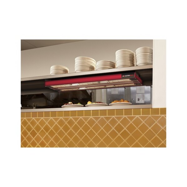 A kitchen counter with a Hatco dual infrared strip warmer above plates and bowls.