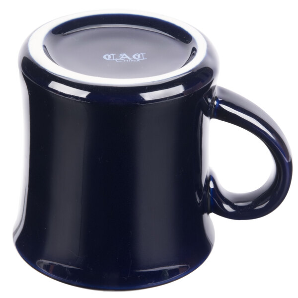A cobalt blue mug with a white rim and handle.