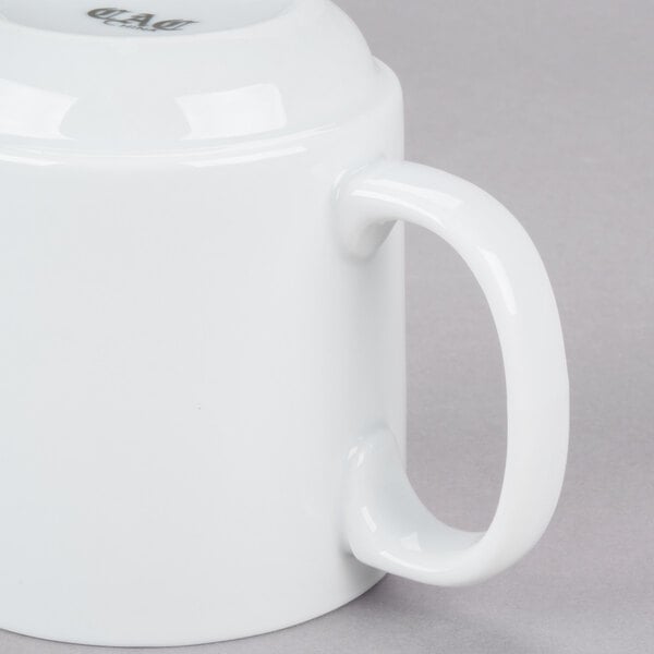 A close up of a bright white CAC Venice stacking mug with a handle.