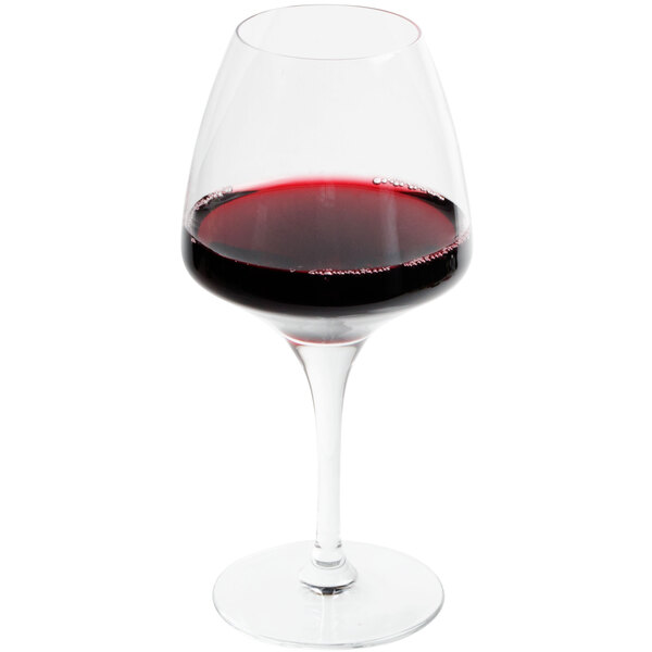 A Chef & Sommelier Pro Wine Tasting Glass filled with red wine on a table.