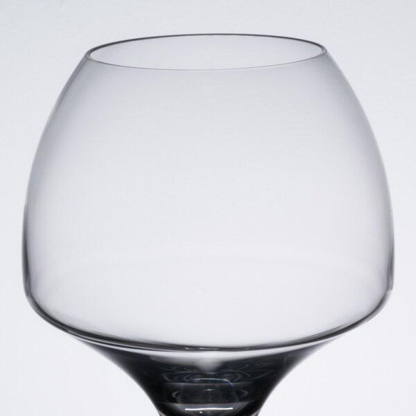A clear wine glass with a black base.