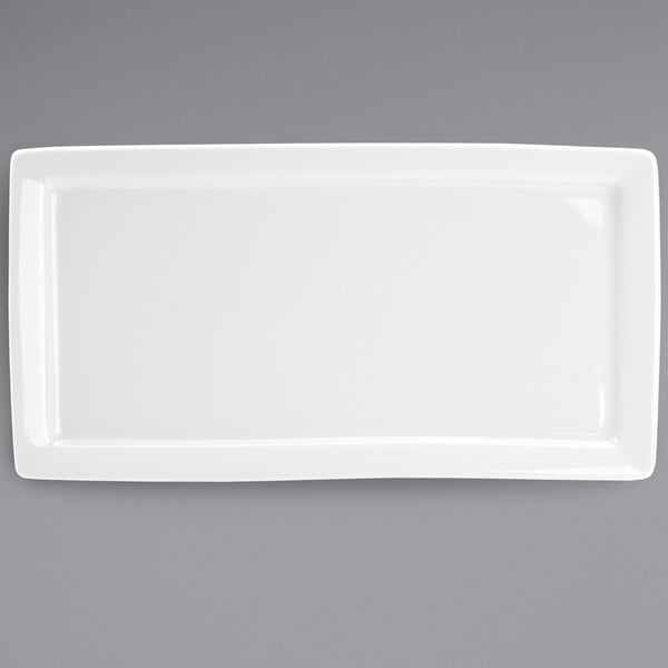 A Tuxton white rectangular china plate with a white rim.