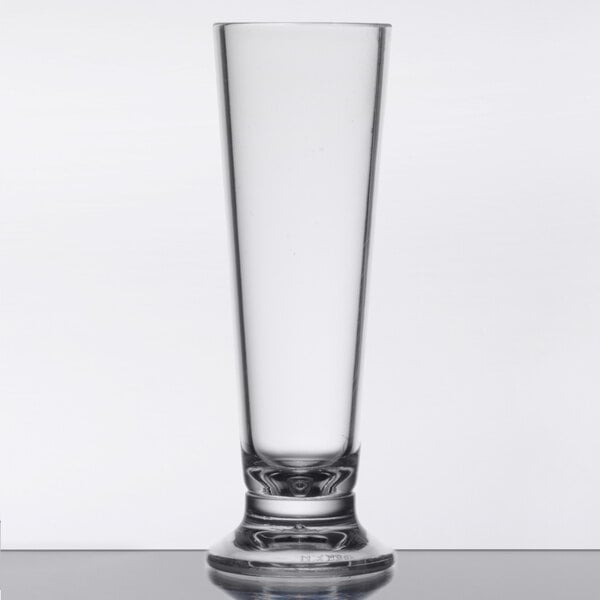 A clear GET SAN plastic dessert shot glass on a table.