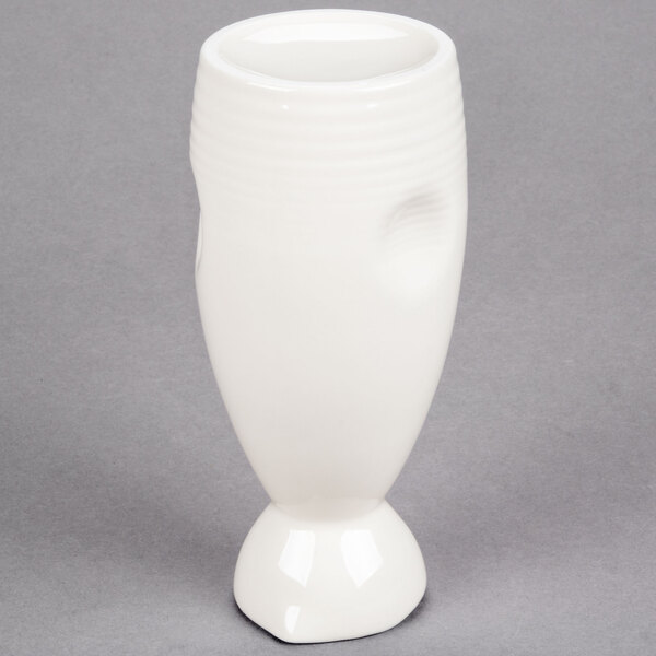 A close-up of a white GET Porcelain Fuji Sake Bottle with a hole in the bottom.