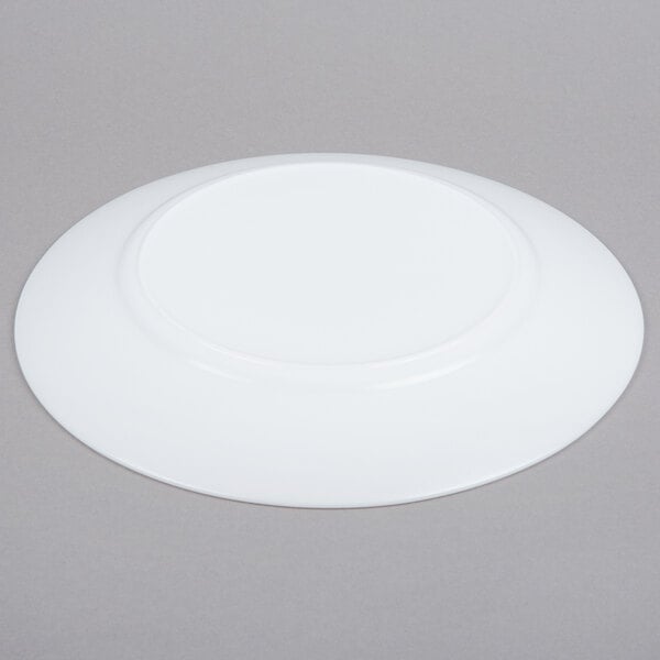 An Arcoroc white glass lunch plate with a circular rim.