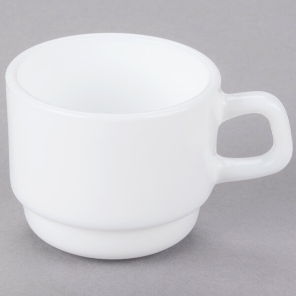 A white Arcoroc cup with a handle.