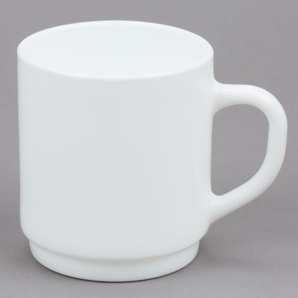 An Arcoroc white stacking mug with a handle.