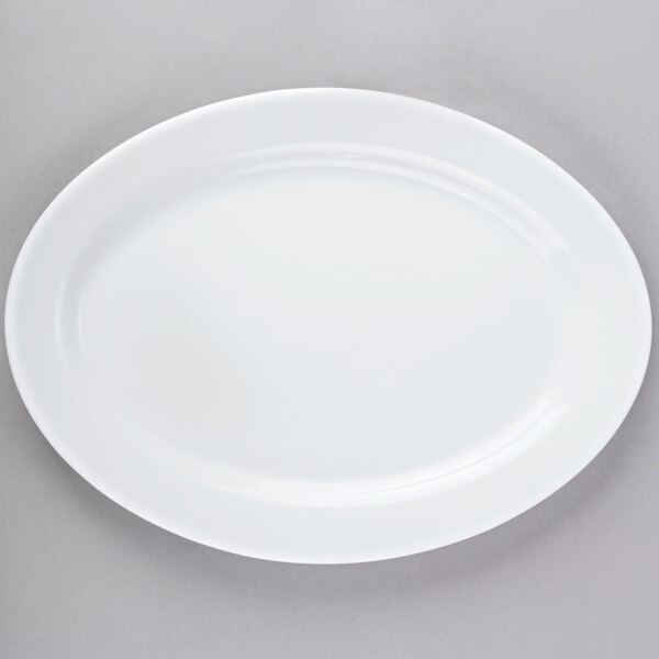 An Arcoroc white opal oval platter with a white rim.