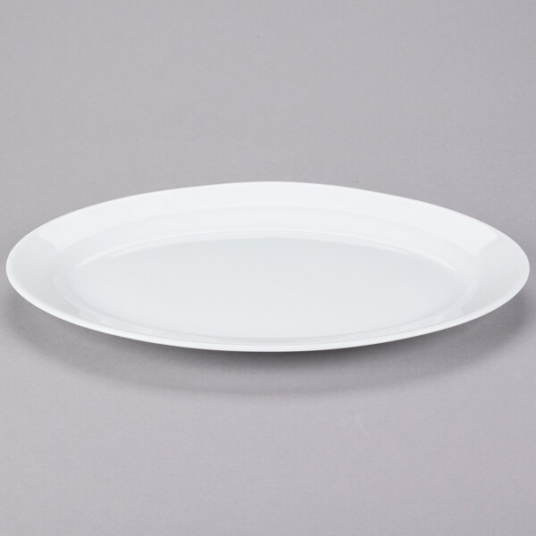 An Arcoroc white oval platter on a gray background.