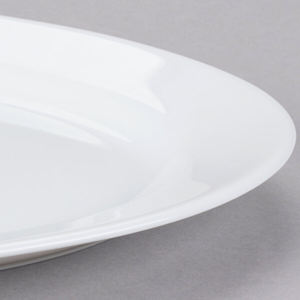 An Arcoroc white oval platter with a rim.