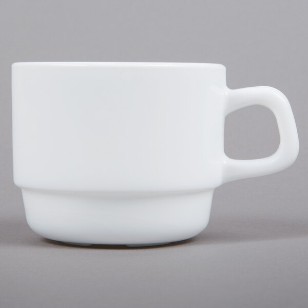 A white Arcoroc cup with a handle.