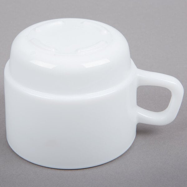 An Arcoroc white cup with a handle.