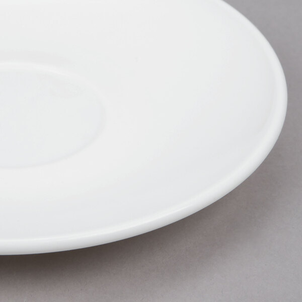 A white Arcoroc saucer with a small rim.
