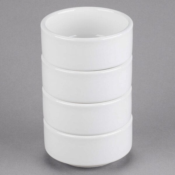 A stack of Tuxton white china bowls.