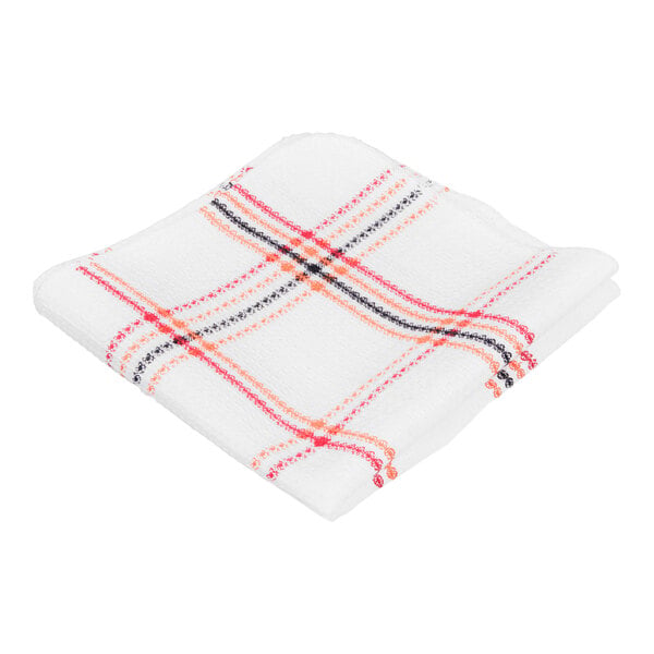 A folded white cloth with a red, orange, and black plaid pattern.