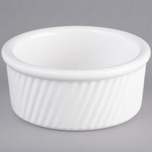 A Tuxton white china ramekin with a ribbed rim.