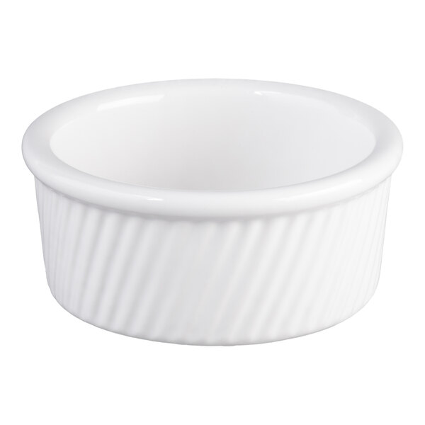 A white china souffle or ramekin dish with swirl sides.