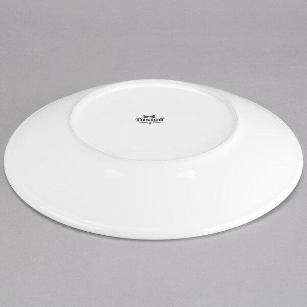 A white Tuxton pasta/salad bowl with a black rim.