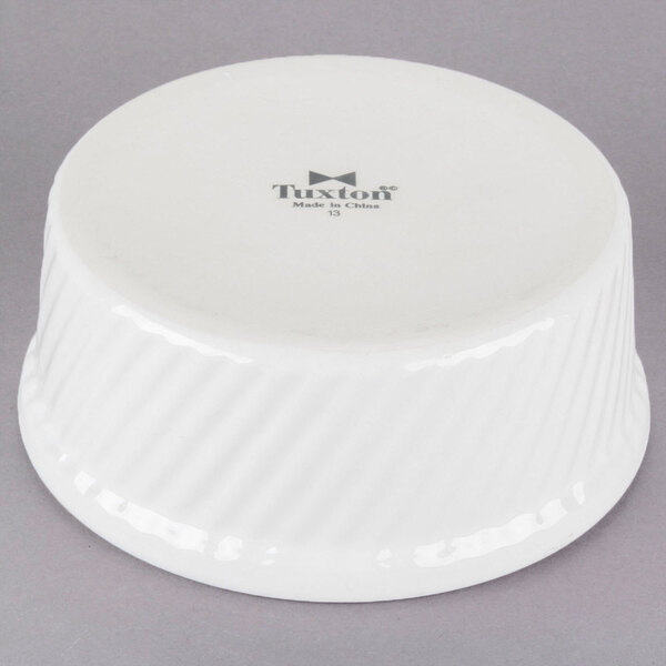 A white Tuxton ramekin with swirl sides.