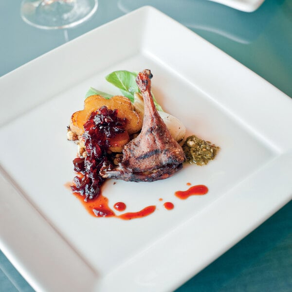 A Tuxton TuxTrendz bright white square china plate with food on it.