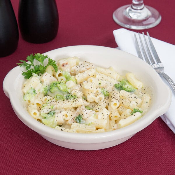 A Tuxton round white china bowl filled with pasta, broccoli, and cheese.
