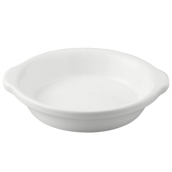 A white Tuxton round au gratin dish with a handle.