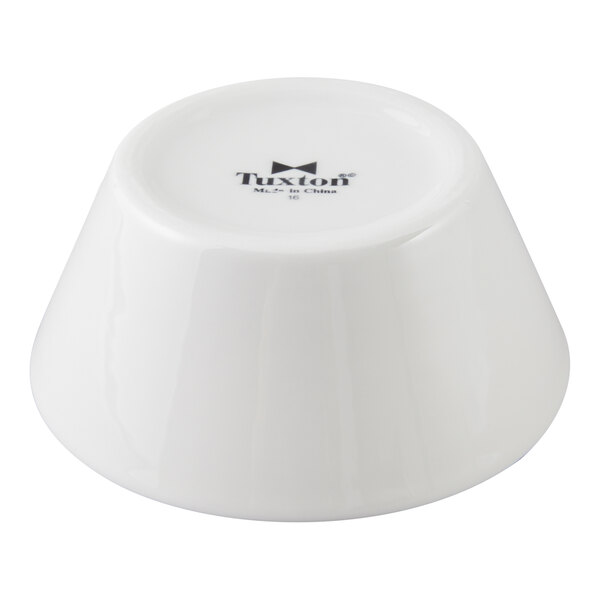 A white porcelain tapered soup bowl turned upside down.