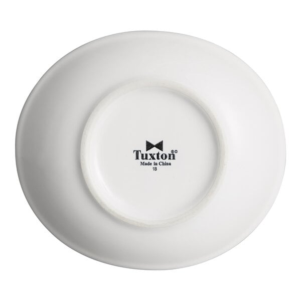 A white oval china bowl with the Tuxton logo and 'Made in China' printed on the bottom.