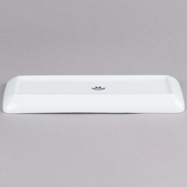 A white rectangular Tuxton china tray with a black logo on it.