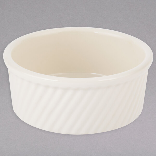 A white Tuxton China ramekin with a ribbed design.