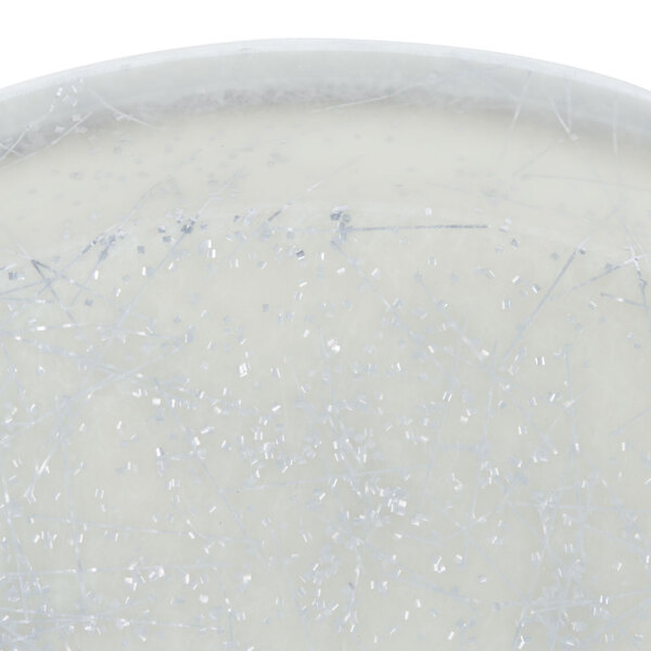 A white plate with silver specks on a white background.