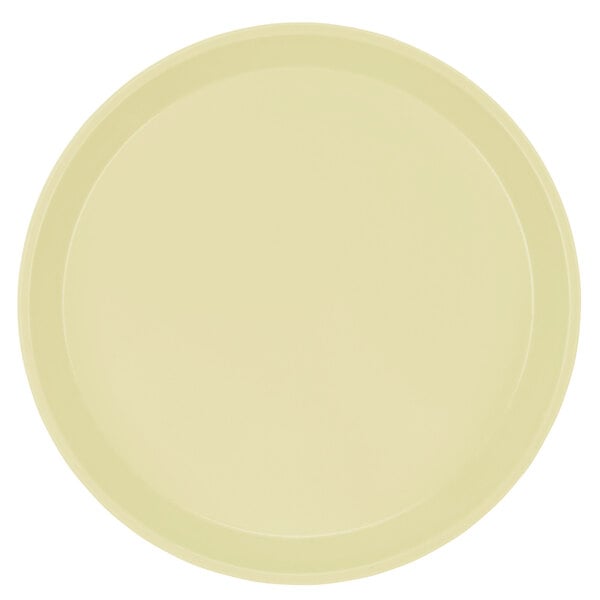 A white round Cambro tray with a yellow rim.