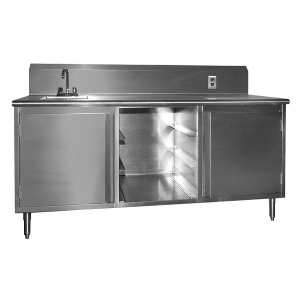 A stainless steel beverage table with a sink on the left and two doors.